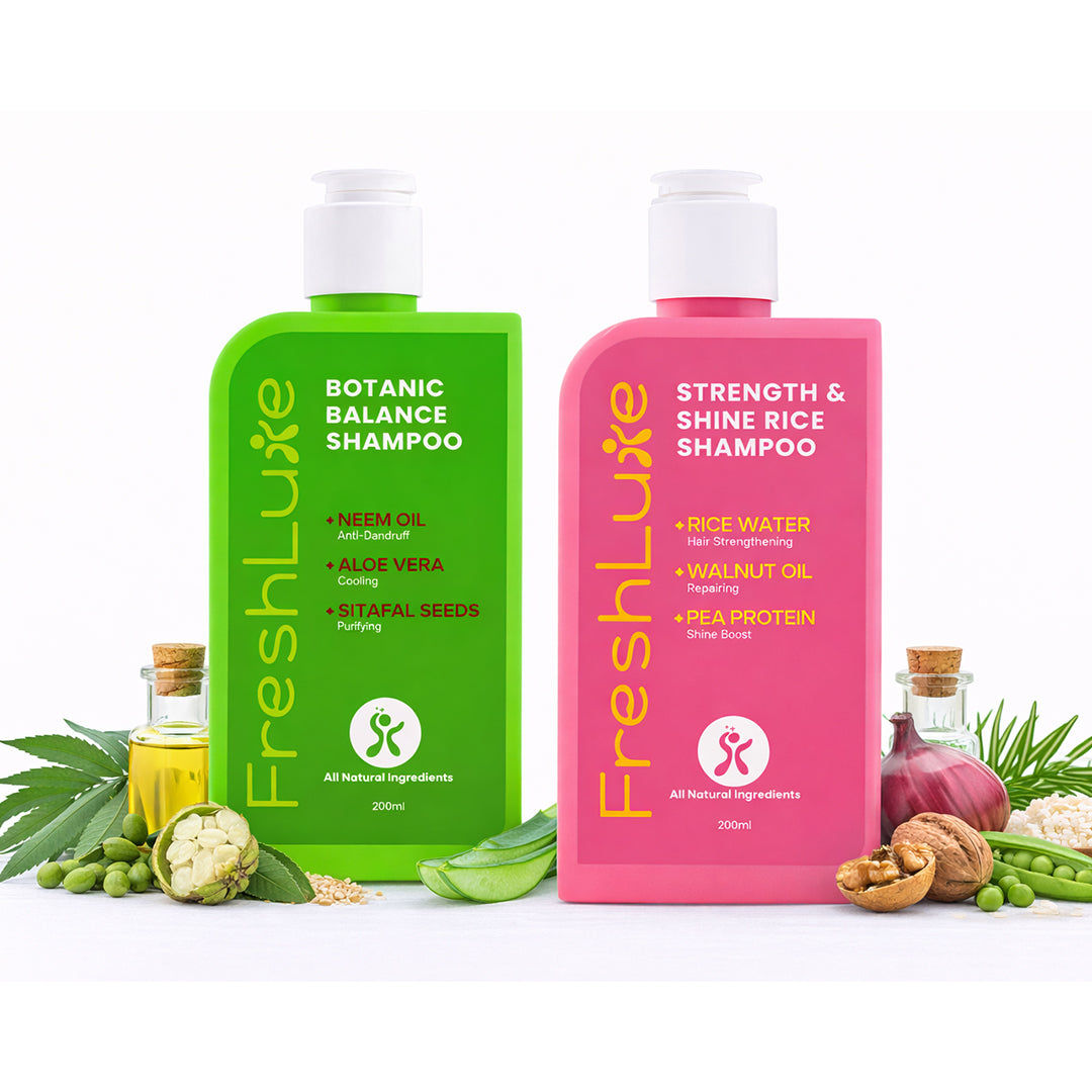 Two bottles of FreshLuxe shampoo, one green and one pink, on a white background with ingredients around.