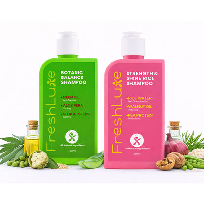 Two bottles of FreshLuxe shampoo, one green and one pink, on a white background with ingredients around.