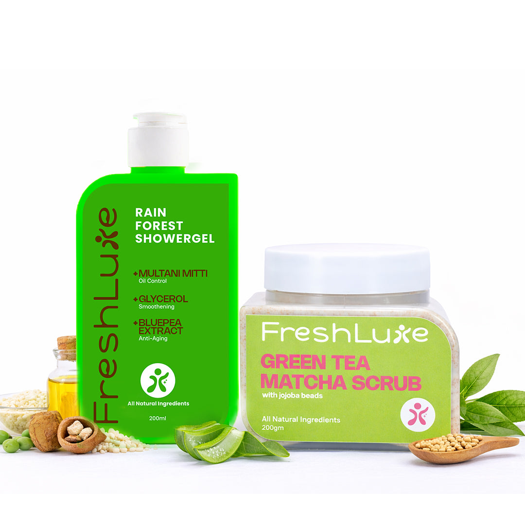 FreshLuxe Rain Forest Showergel and Green Tea Matcha Scrub on a white background with green leaves.